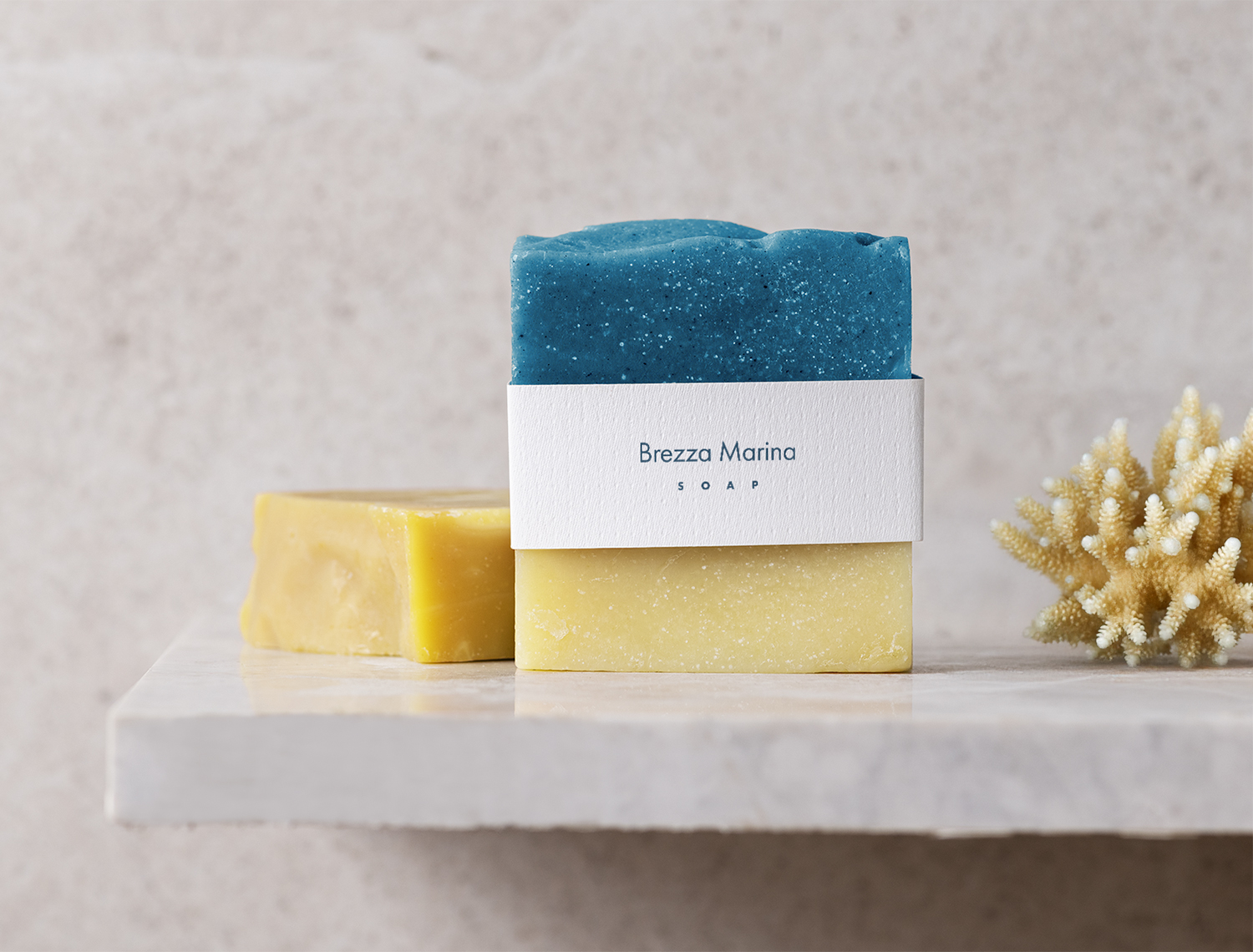 Brezza Marina Rooms branded soap packaging with blue and yellow bars